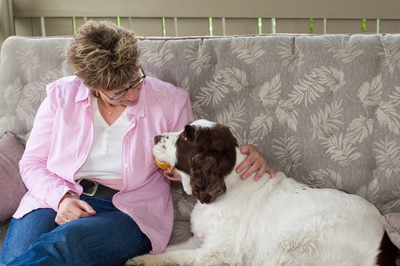 Barbara Rissmann relaxing at home with her dog